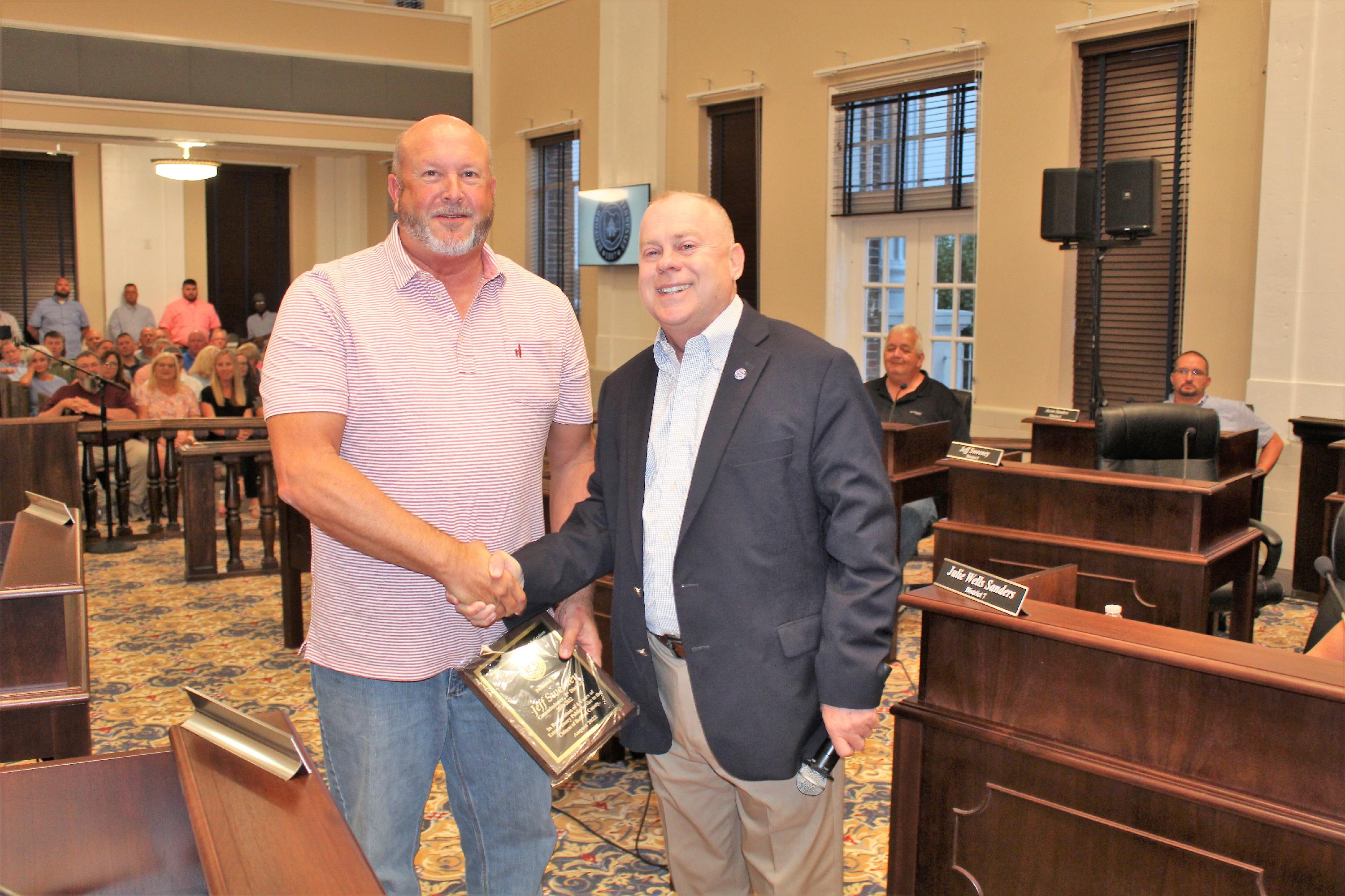 Jeff Sweeney receives a plaque from County Mayor Chad Graham in the second floor courtroom at Bedford County Courthouse.